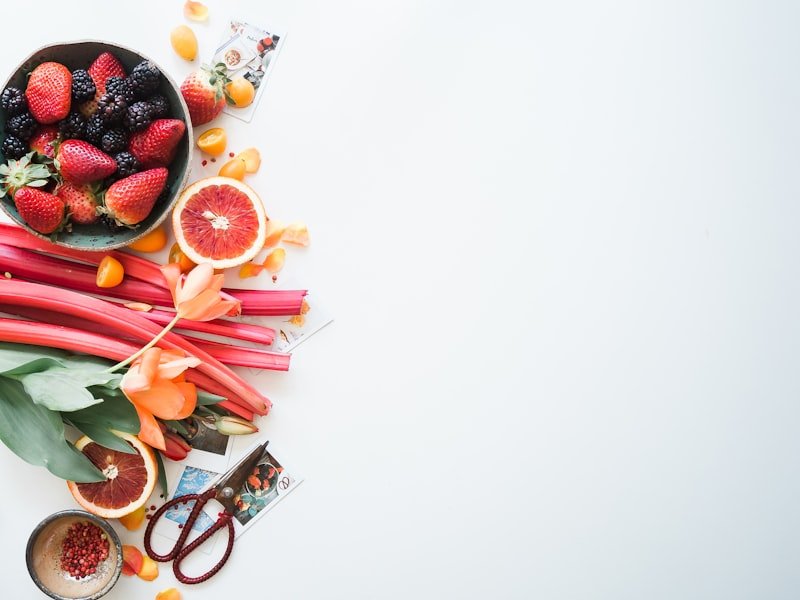 Antioxidant-rich flat-lay of berries, blood orange and rhubarb — anti-inflammatory foundations for autoimmune care