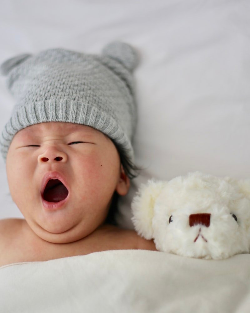 Sleeping infant in soft knit hat — gentle pediatric and family care